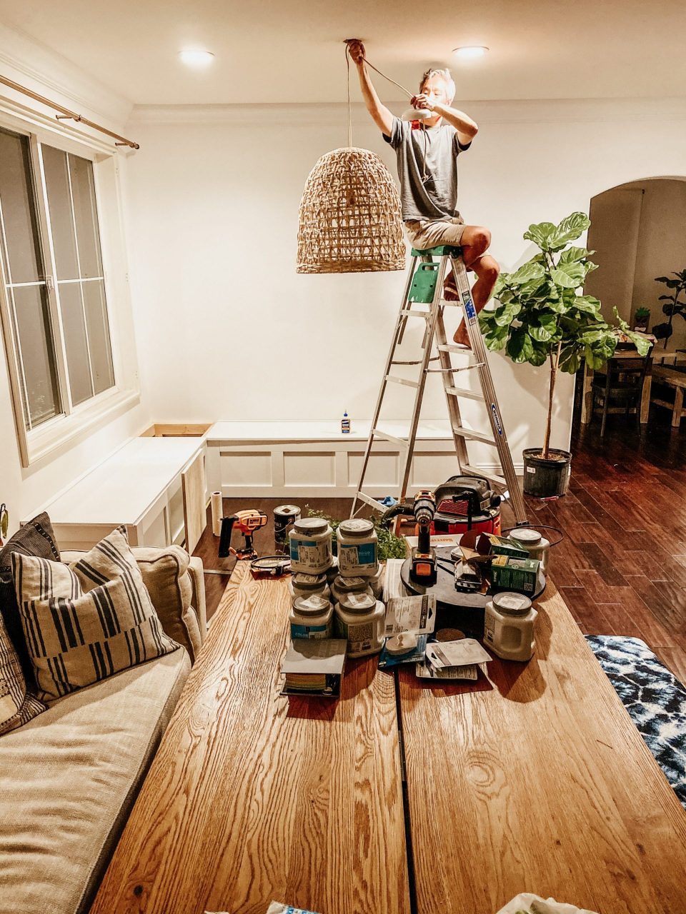 Travis hangs a pendant light in our in-progress Dining Room