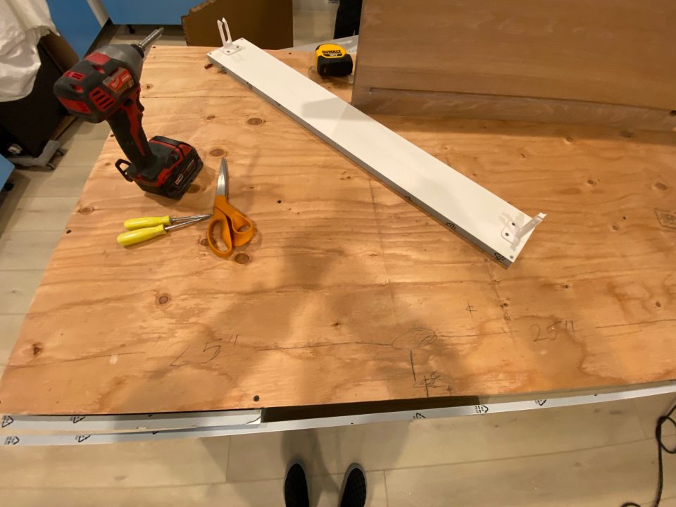 The wooden base for the countertops with measurements penciled all over