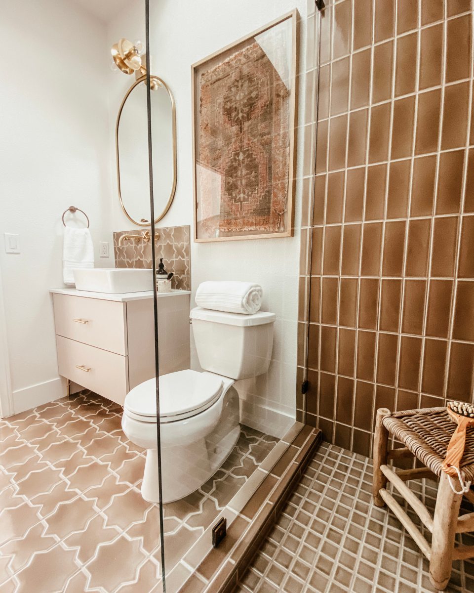 The desert bathroom seen from the shower. The fireclay tile is perfectly accented by the new cabinet and brass fixtures