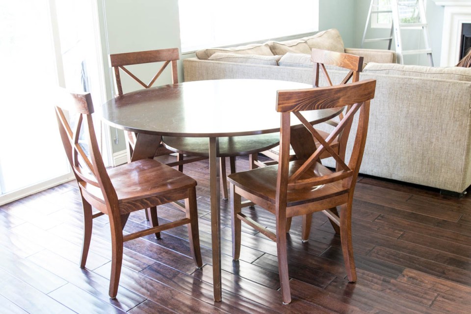 round wood brown table with pottery barn X back chairs 