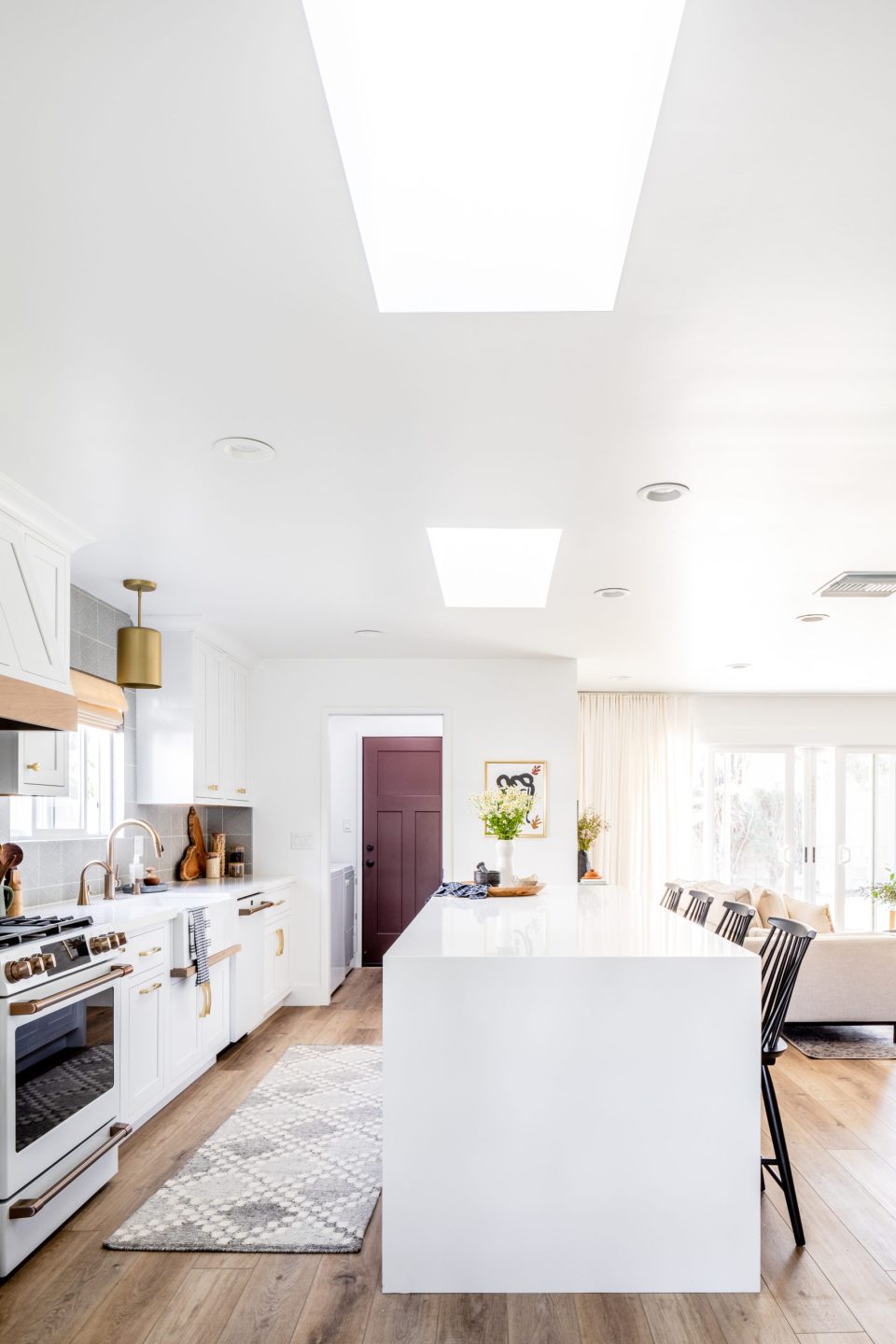 A view into the kitchen, with its sunny skylights and waterfall island