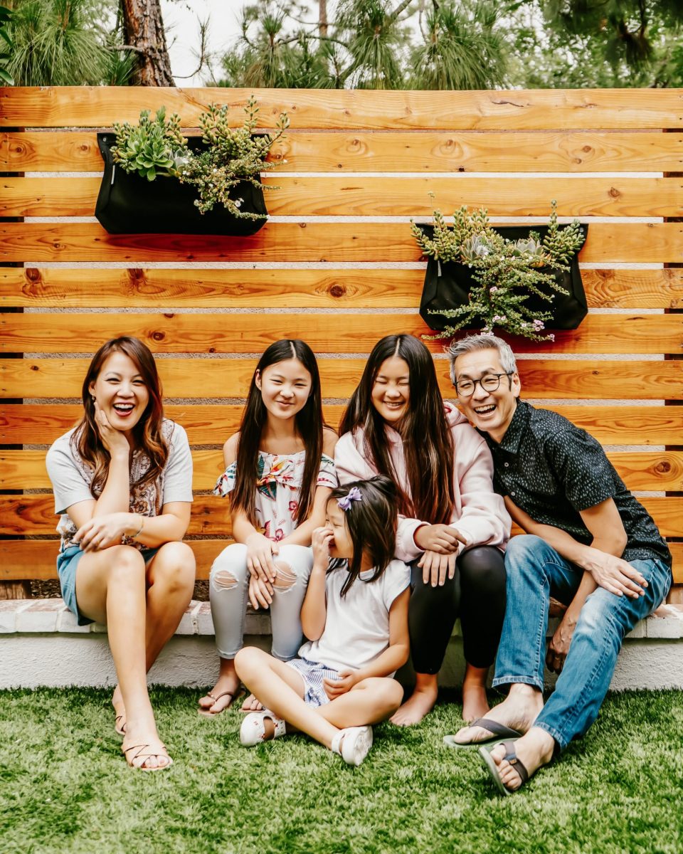 The Yokota family smiles in the back yard of their home