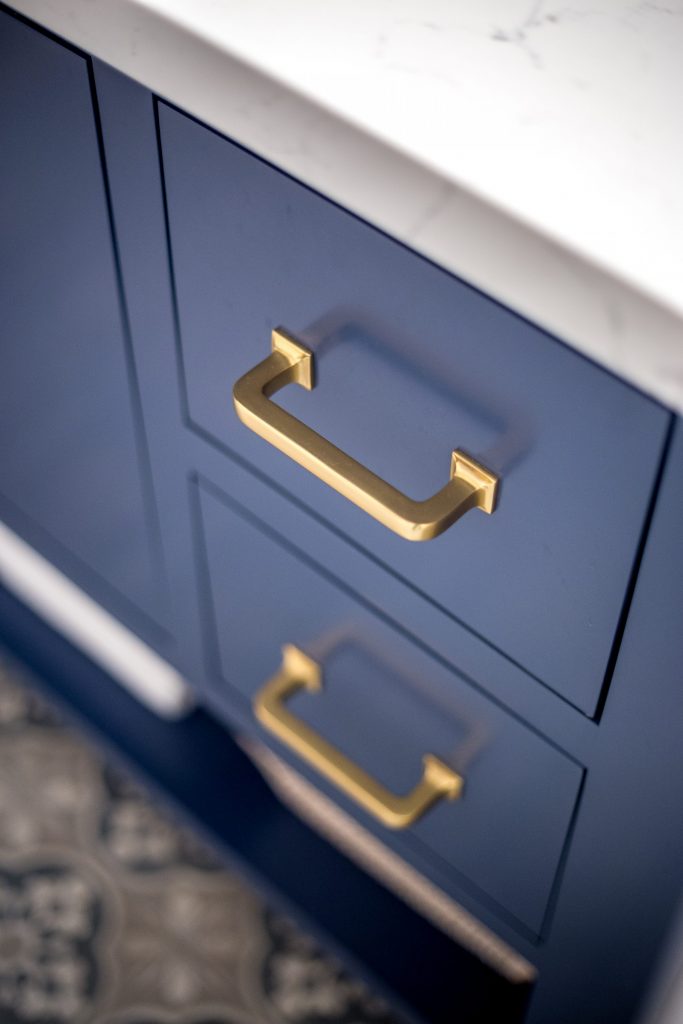 quartz countertop, blue vanity, brass hardware