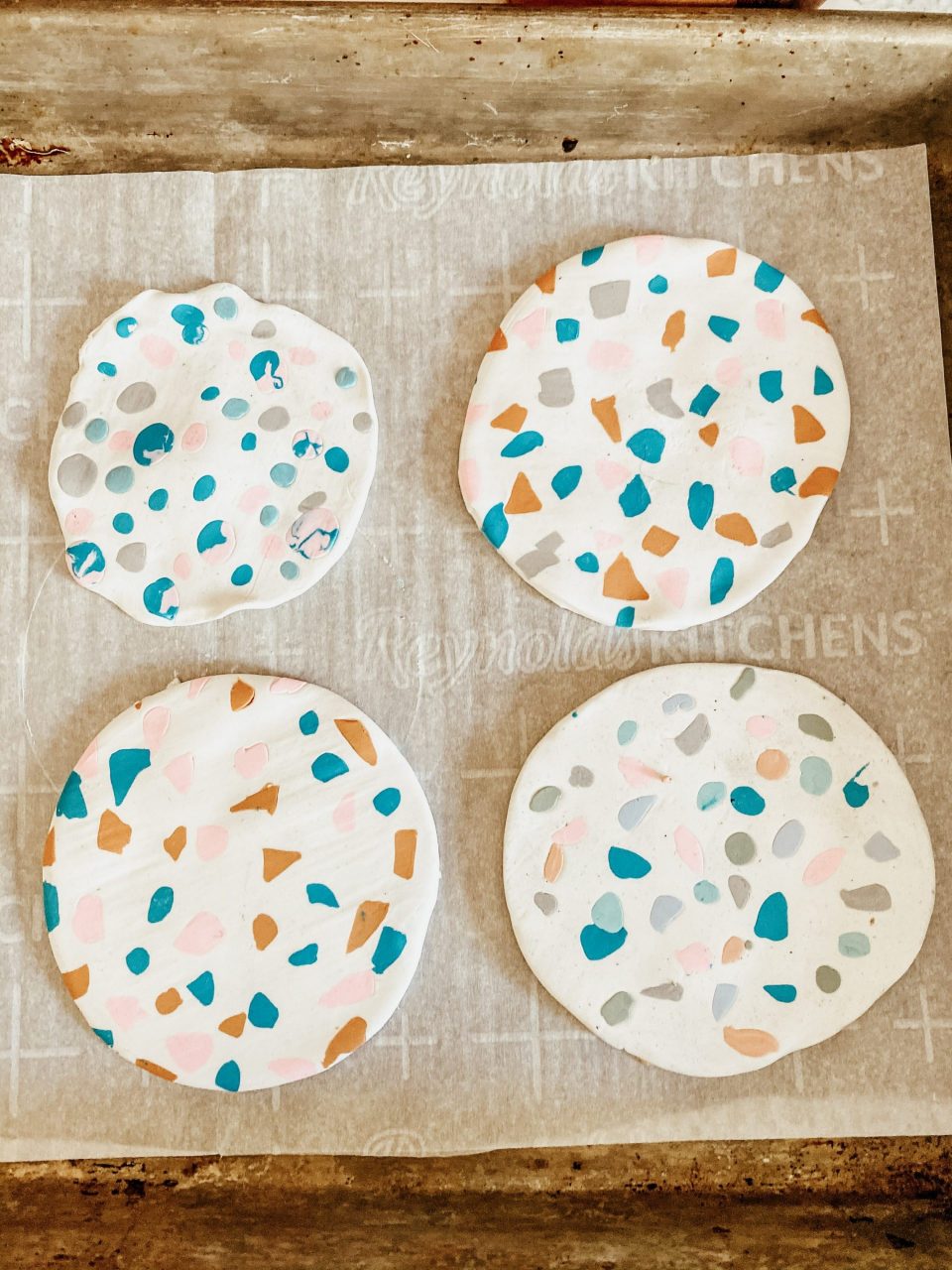 4 completed terrazzo coasters, and you can tell whose is whose!