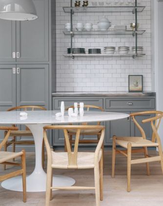 White acrylic Tulip Table featured in grey kitchen 