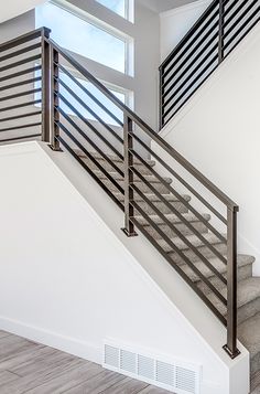 Elevate your lifestyle with a contemporary railing. Home design by Candlelight Homes, we build beautiful!