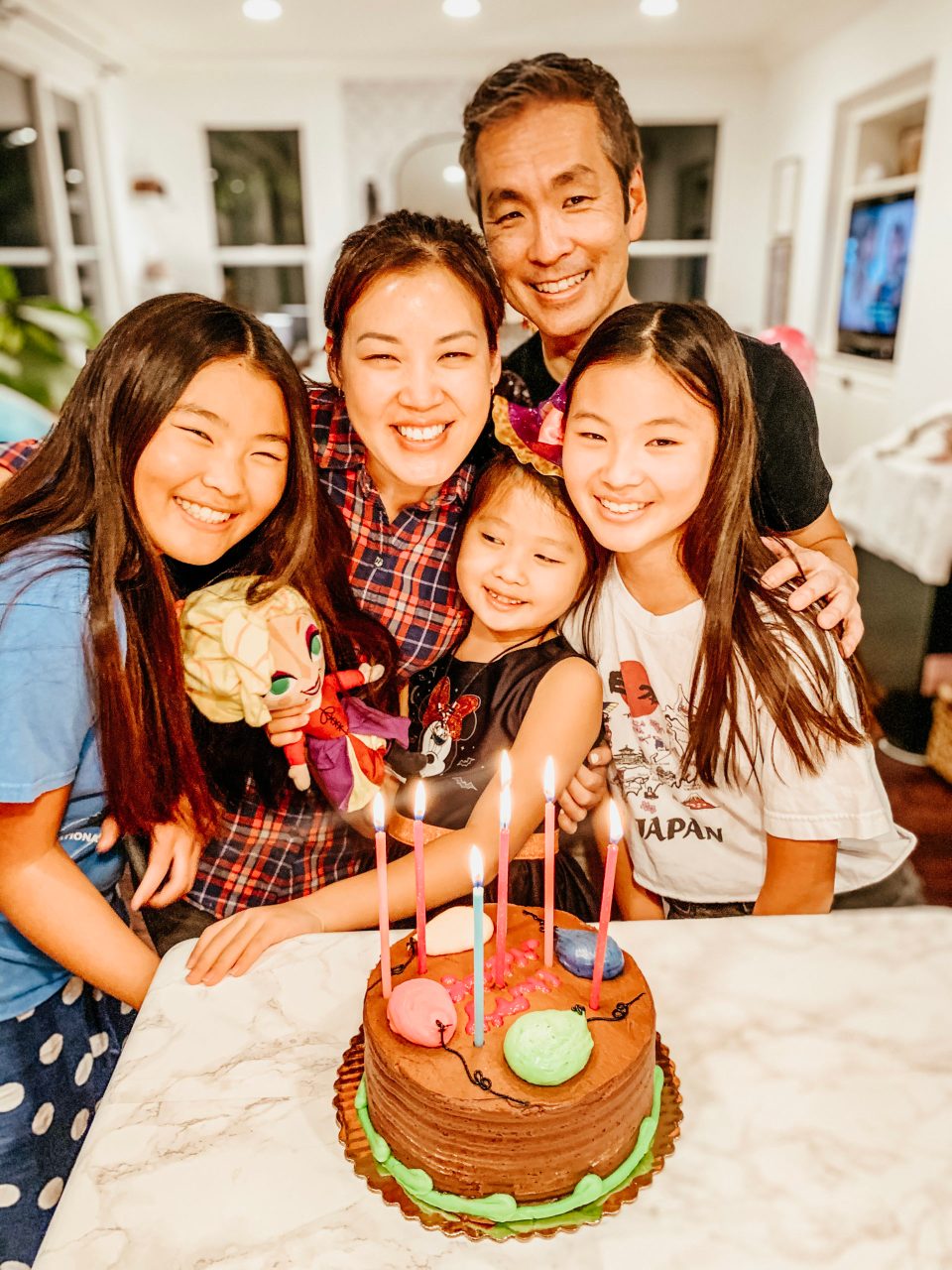 A sweet family moment, all five Yokotas gathered around a cake for Natalie's birthday