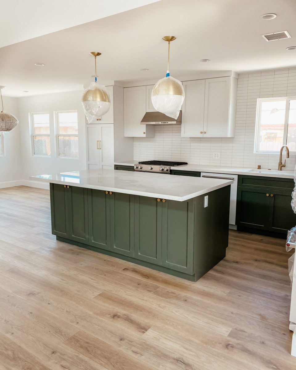 The full two-toned kitchen, complete with modern brass light fixtures
