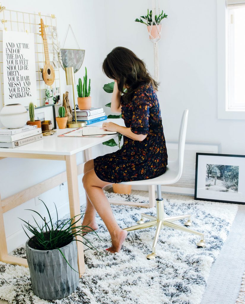 Designer Anita Yokota Sitting at mid-century scandanavian desk