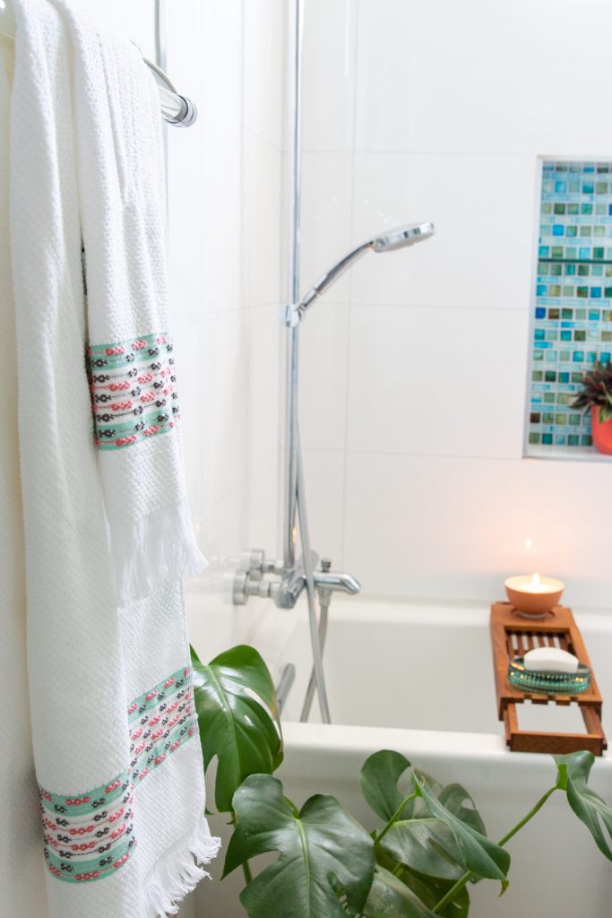 white bathroom blue and green glass tile Drew Barrymore flower line Walmart