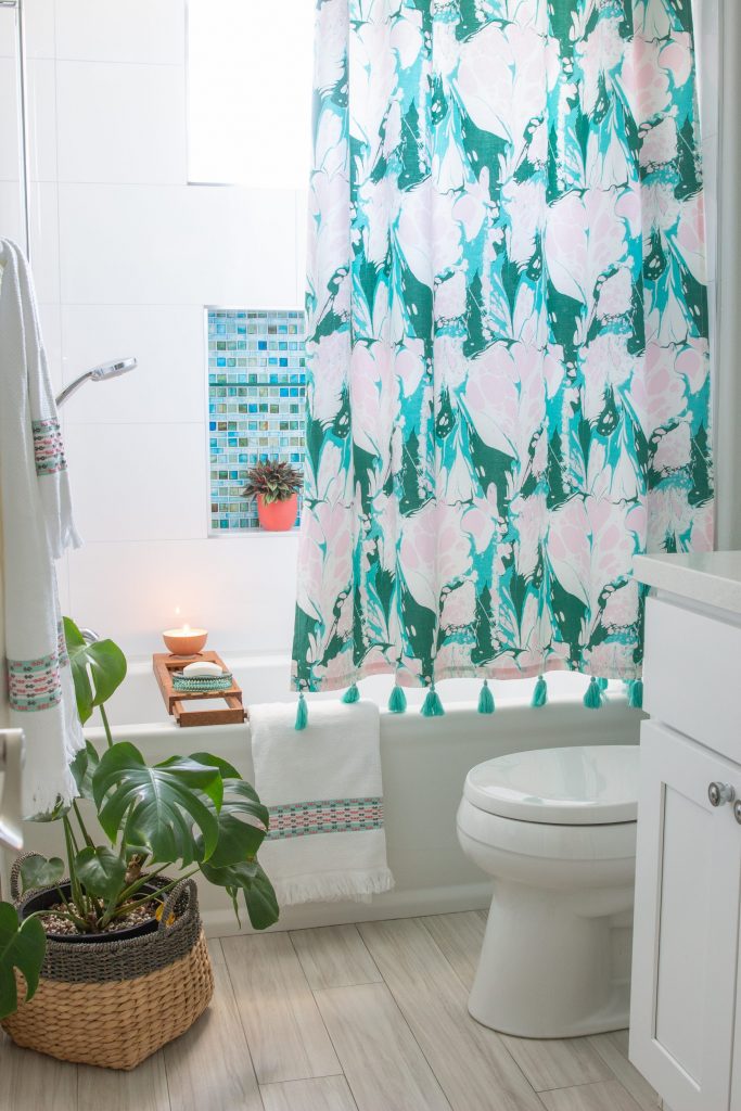 white bathroom blue and green glass tile Drew Barrymore flower line Walmart