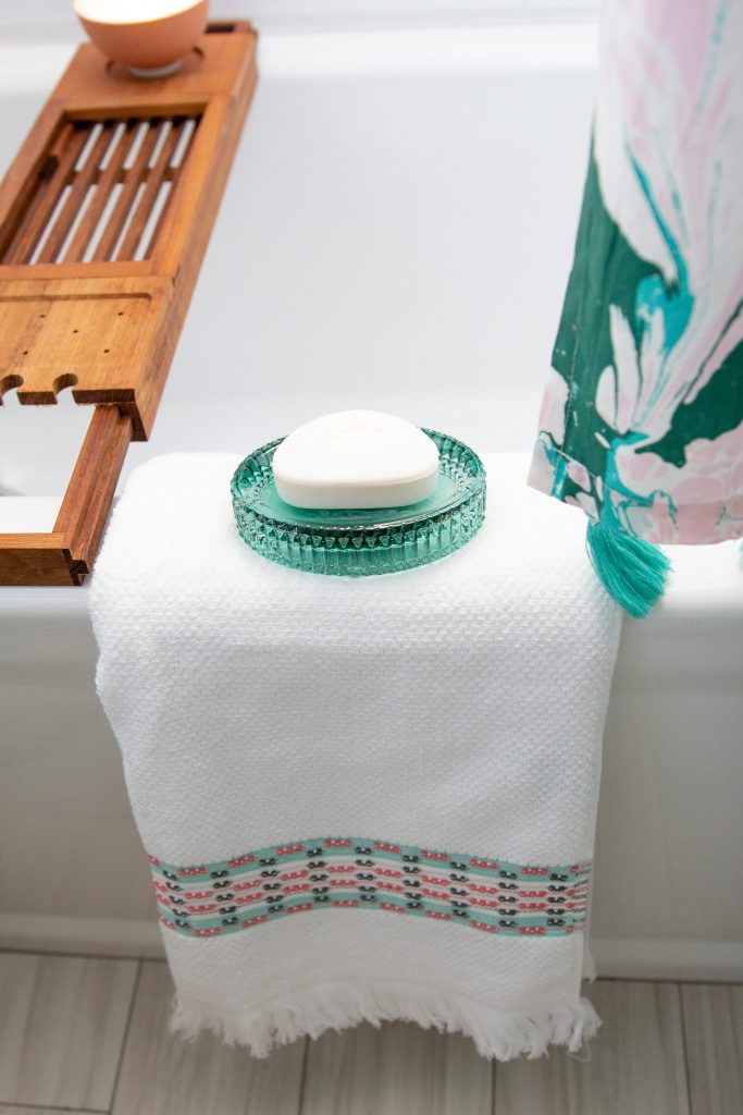 white bathroom blue and green glass tile Drew Barrymore flower line Walmart