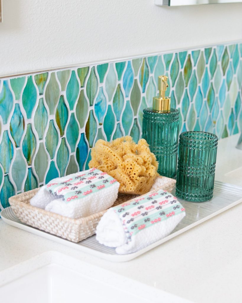 white bathroom blue and green glass tile Drew Barrymore flower line Walmart