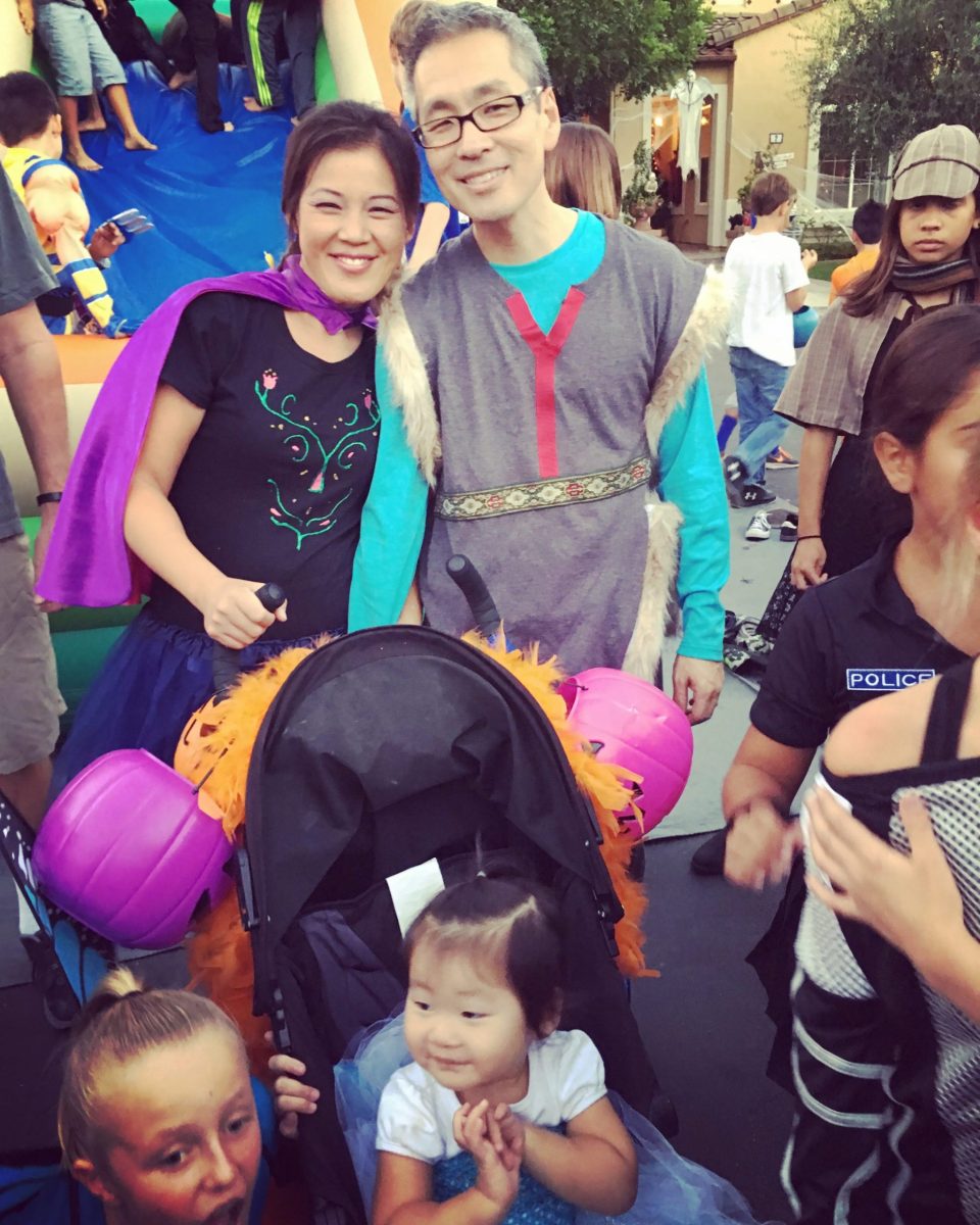 Anita & Travis as Anna & Kristoff with Natalie in a stroller at a past block party 