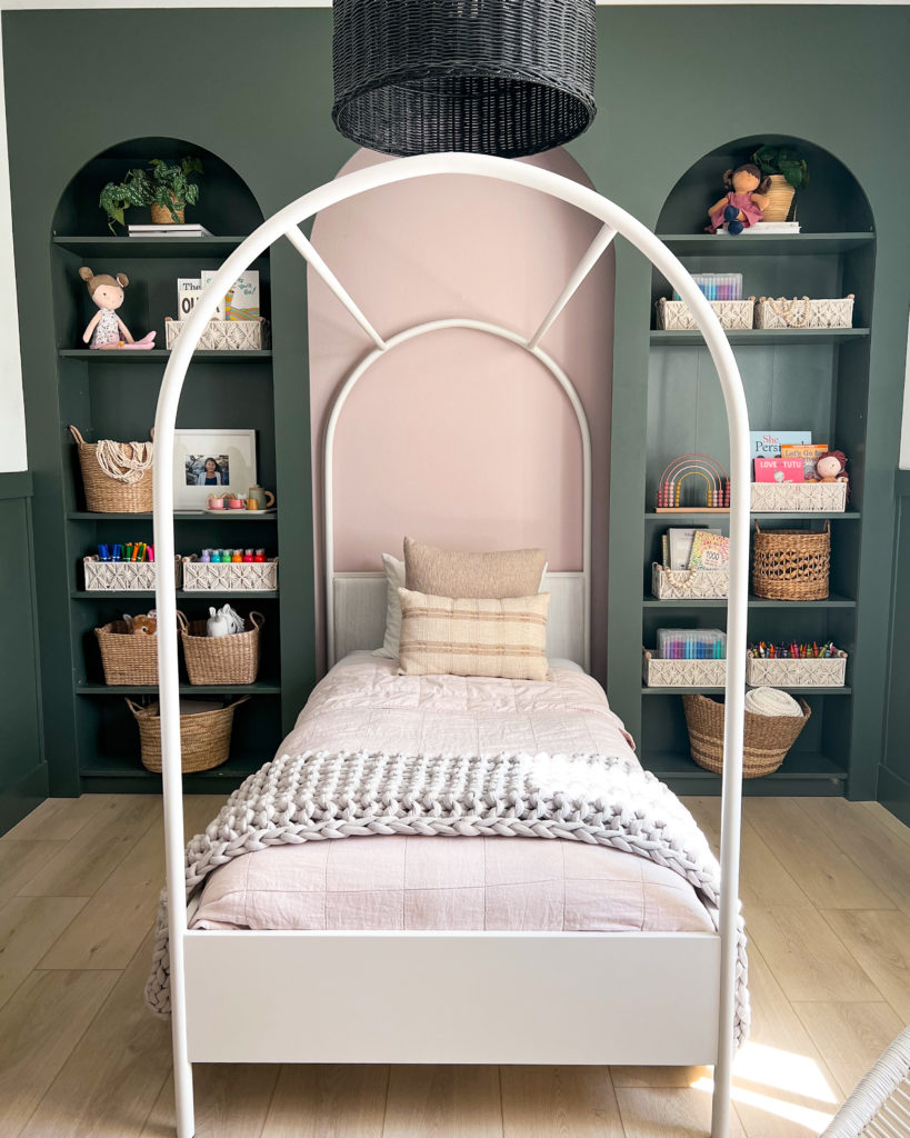 The arched canopy bed, framed by arched bookcases for a modern fairy tale