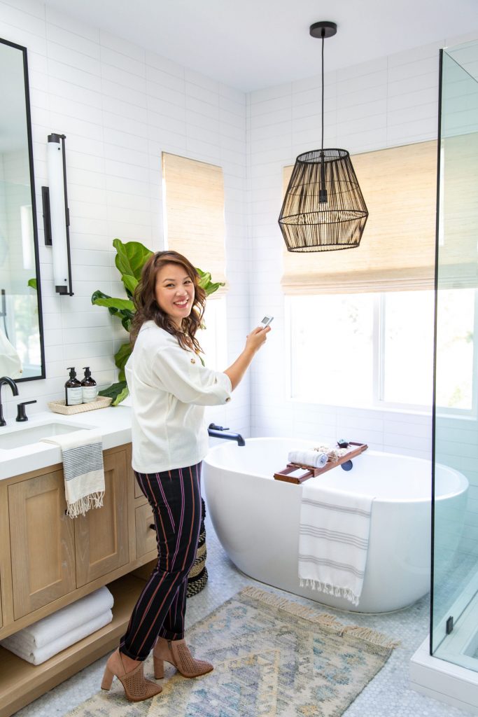 woven shades, black pendant, modern bathroom, free standing tub, oak vanity, black fixtures