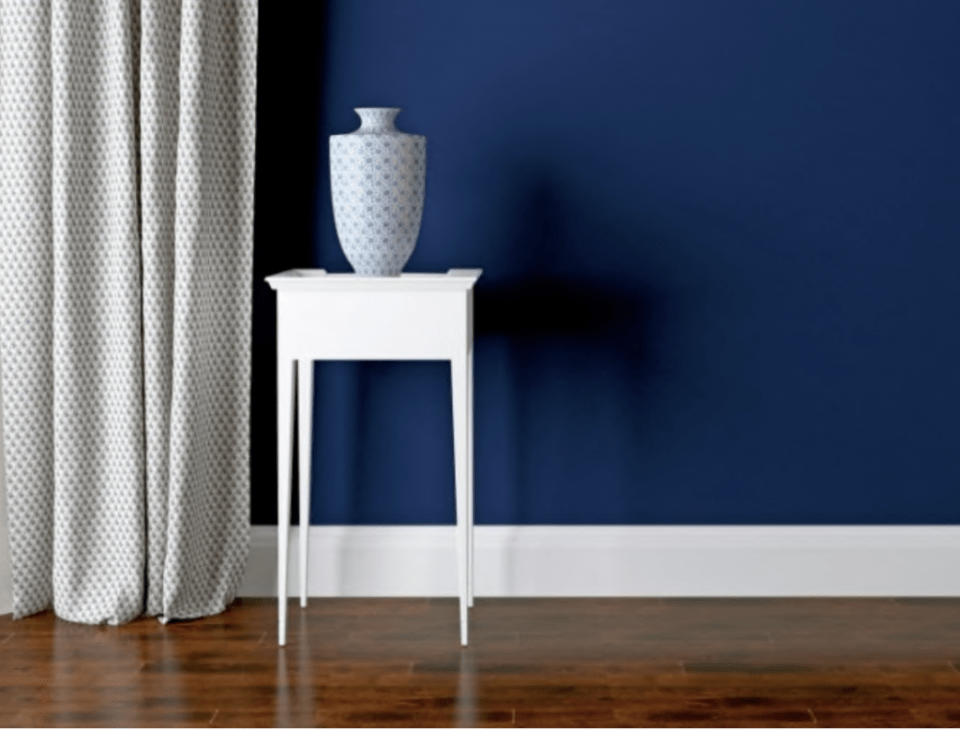 white baseboards navy wall drapery