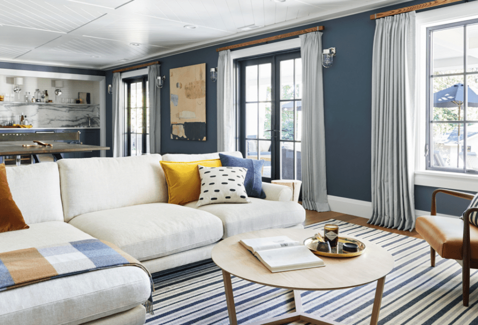 media room Emily Henderson living room blue white baseboards